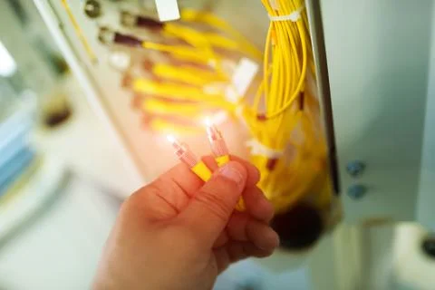 People fix node fiber optic in network room Stock Photos