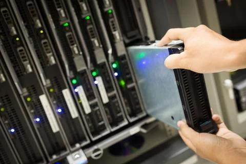 People fix node fiber optic in network room Stock Photos