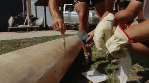 People fixing a canoe Stock Footage 12265084
