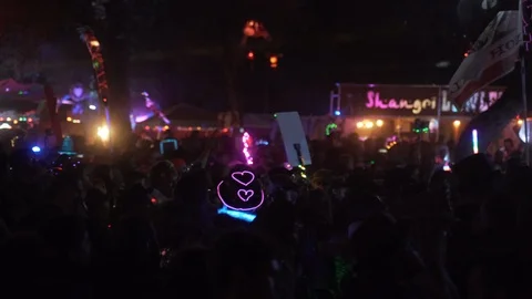 People with flags dancing at outdoor electronic music festival Stock Footage 122379534