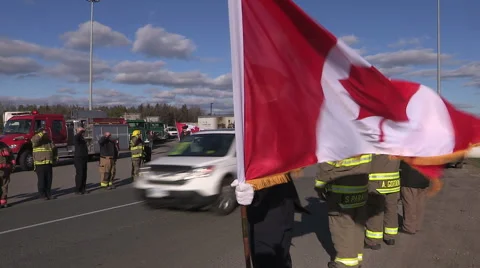 People with flags wait funeral procession for fallen Canadian soldier from Syria Stock Footage 57349796