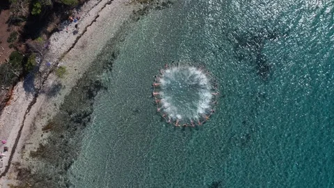 People floating in a circle holding hands on the turqouise Adriatic sea Stock Footage 120693188