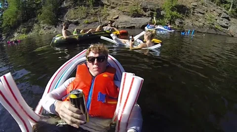 People floating down a river having fun Stock Footage 27884751