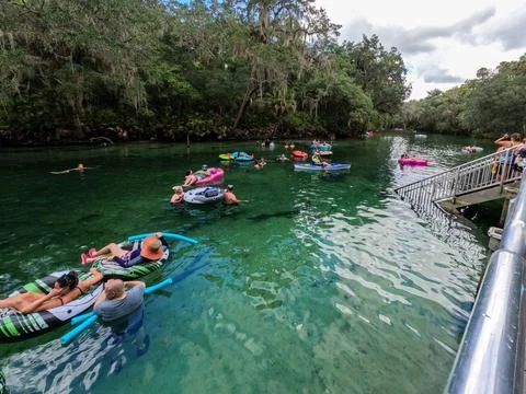 People floating down the spring in Blue Springs State Park in Florida. Stock Photos
