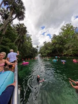 People floating down the spring in Blue Springs State Park in Florida. Stock Photos