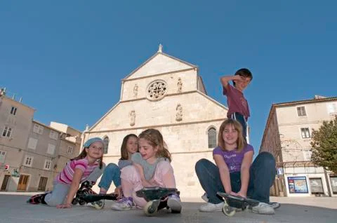 People in front of Medieval Church, Rab Croatia Фото
