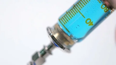 People gaining a syringe with a liquid solution on a white background Stock Footage 72444125