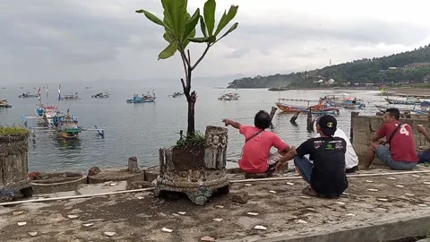 People gather on the beach while looking at the scenery Stock Footage 212494886