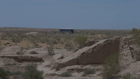 People get off the bus brought to the desert Refraction fluctuation of the air Stock Footage 124371374