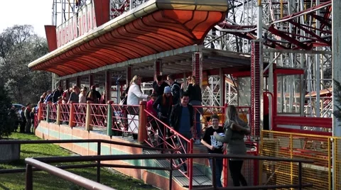 People get off from seats of  roller-coaster in funfair Stock Footage 62176269
