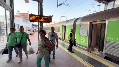 People get off the train at the train station in Aveiro, Portugal. The platform Stock Footage 247093567