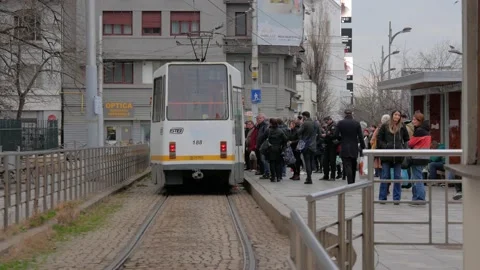 People get on a tram at a stop in Bucharest, Romania. Stock Footage 142755053
