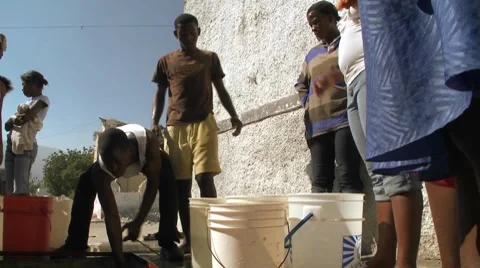 People get water from a well following a massive earthquake in Haiti. Stock Footage