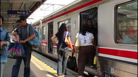People getting on and off the train at jakarta railway station Stock Footage 339917000