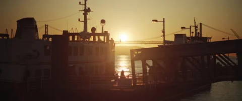 People getting on a ship in a city port at sunset. Beautiful golden hour silh Stock Footage 147567331
