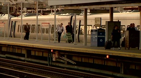 People getting off train wide still shot walking with bags to station travelers Stock Footage 45866483