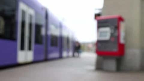 People getting of a tram by ticket machine, blurred background establisher Stock Footage 270572436
