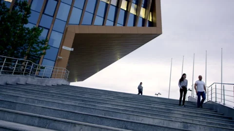 People go down concrete stairs with metal railings on street Stock Footage 240849246