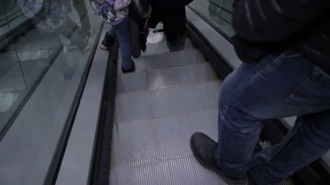 People go down on escalator. Using transport technology to easy move Stock Footage 76011973