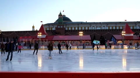 People go skating at sunset in the evening. Skating rink Stock Footage 181817898