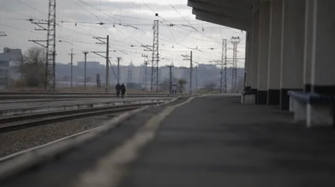 People go through the train station along the rail Stock Footage 60607838