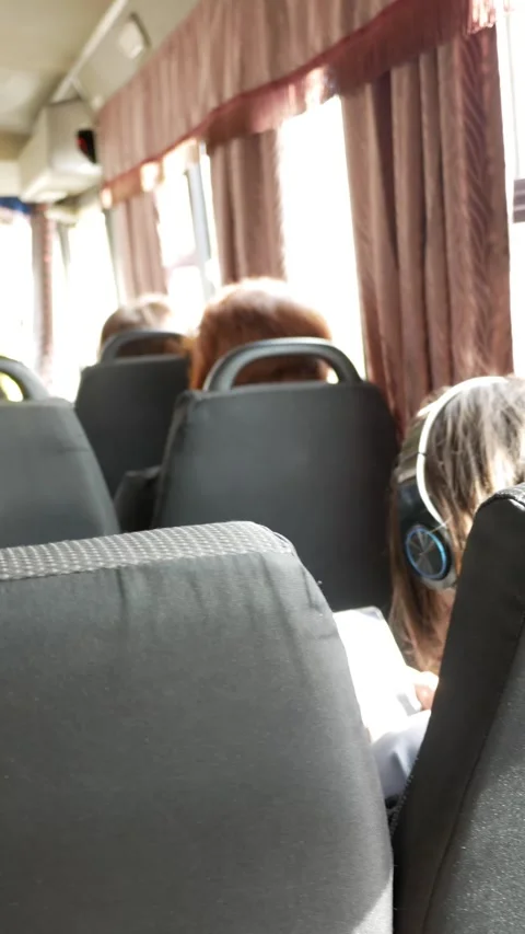 People go to work on public bus. Passengers riding on a bus. Rays of the sun. Un Stock Footage 285140694
