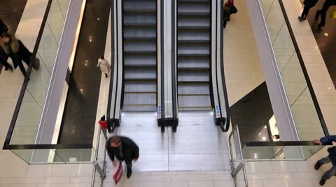 The people going up and down on the floor on escalator in the mall Stock Footage 44337841