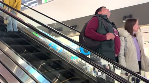 People going down an escalator in a shopping center Stock-Footage 254387357