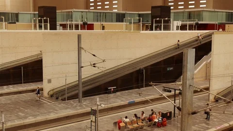 People going down to platforms on conveyor in the Zaragoza train-station. Aragon Stock Footage 98497626