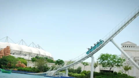 People going down on speedy rollercoaster attraction in amusement park Stock Footage 196155714