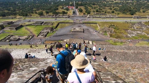 People going down from the top section of the pyramid of the sun Stock Footage 98004678