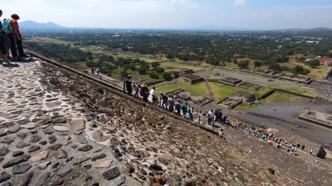 People going down from the top section of the pyramid of the sun Stock Footage 98004778