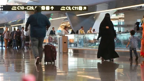 People going to their flights at Doha Airport - Qatar Stock Footage 73356663