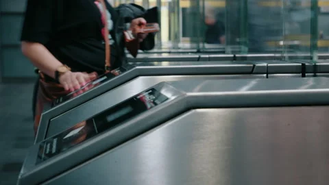 People going through automatic turnstiles in subway station, ticket scanner Stock Footage 243365772