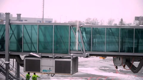 People going through jet bridge from plane to the airport. Stock Footage 103397977