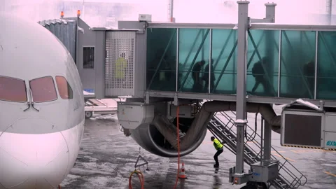 People going through jet bridge from plane to the airport. Stock Footage 103398360