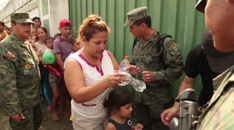 People going through a line and taking water bottles, 2016 Ecuador quake Stock Footage 62832627