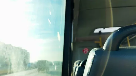 People going to work. They look out the window. Sunny day. Cars driving through  Stock Footage 143379917