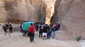 People in gorge that leads to Red Rose City Of Petra in Jordan HD Footage