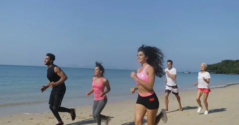 People Group Running On Beach Young Men And Women Athlete Jogging Training Stock Footage