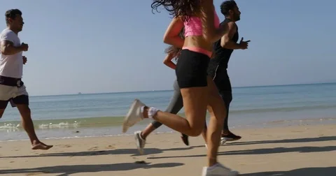 People Group Running On Beach Young Men And Women Athlete Jogging Training Stock Footage 75217764