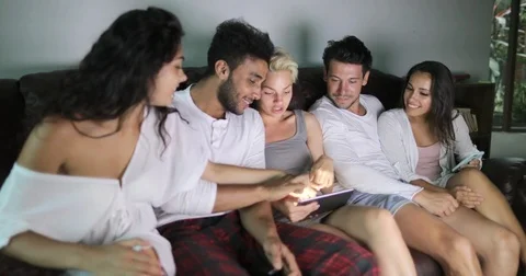 People Group Sitting On Couch Using Tablet Computer Watching TV Program Talking Stock Footage 75835747