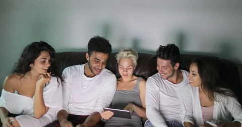 People Group Sitting On Couch Using Tablet Computer Watching TV Program Talking Stock Footage 75835751