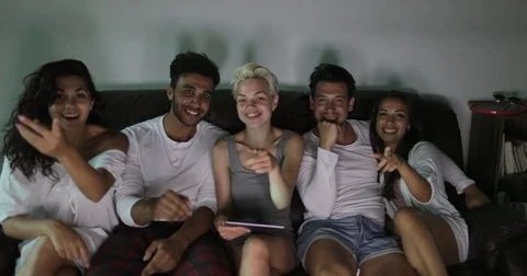 People Group Sitting On Couch Watching TV Program Talking, Young Friends Using Stock Footage 75839401