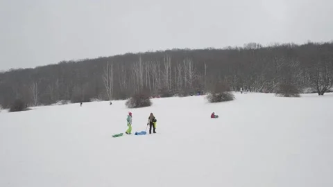 People group sledging sledge winter hill snow local children Stock Footage 148334226