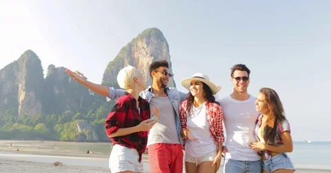 People Group Talking On Beach Taking Selfie Photo On cell Smart Phone Young Men Stock Footage 74855323