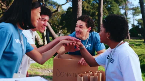 People, hand stack and outdoor for volunteering, food drive and teamwork success Stock Footage 347176394