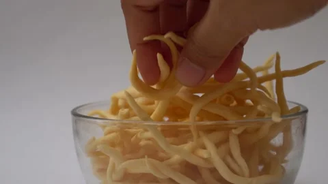 People hand taking snack cheese stick on transparent bowl Stock Footage 211789557