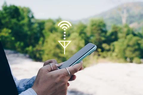 People hand using smartphone looking for signal wifi in off the grid no pow.. Stock Photos