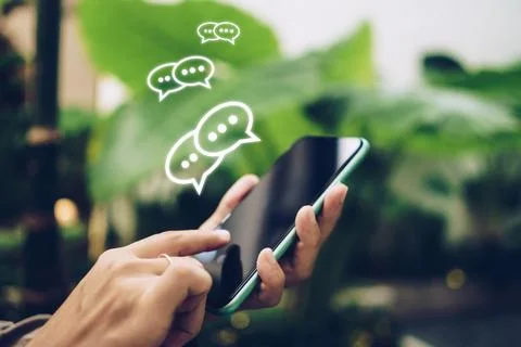 People hand using smartphone typing, chatting or text messages in chat icon.. Stock Photos